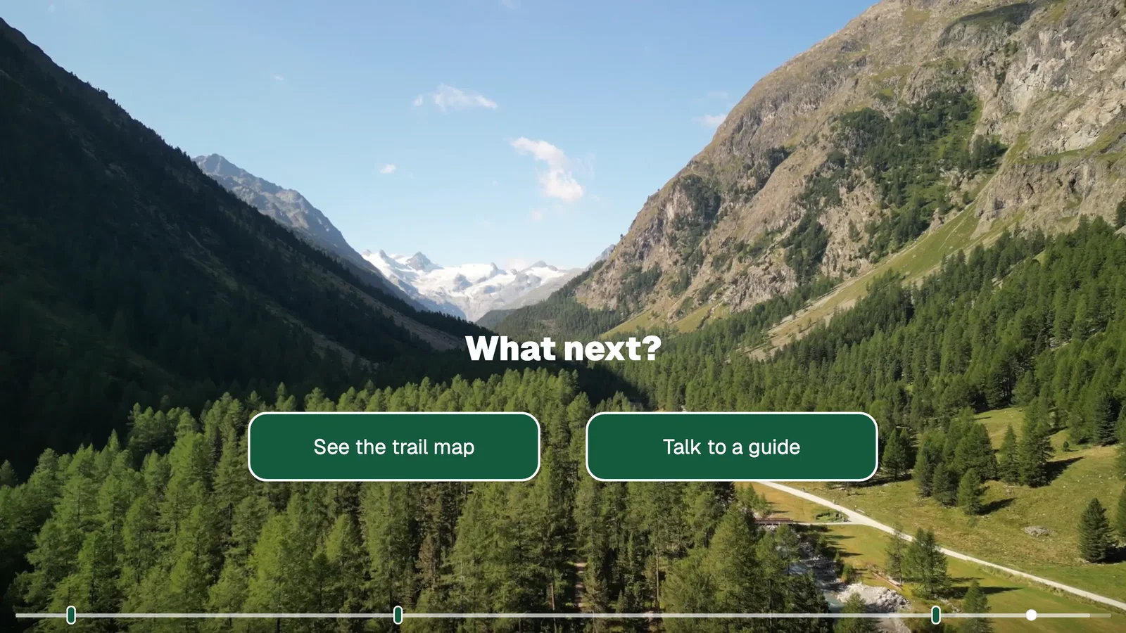 A mountain valley video with the text What next? and two buttons, See the trail map and Talk to a guide